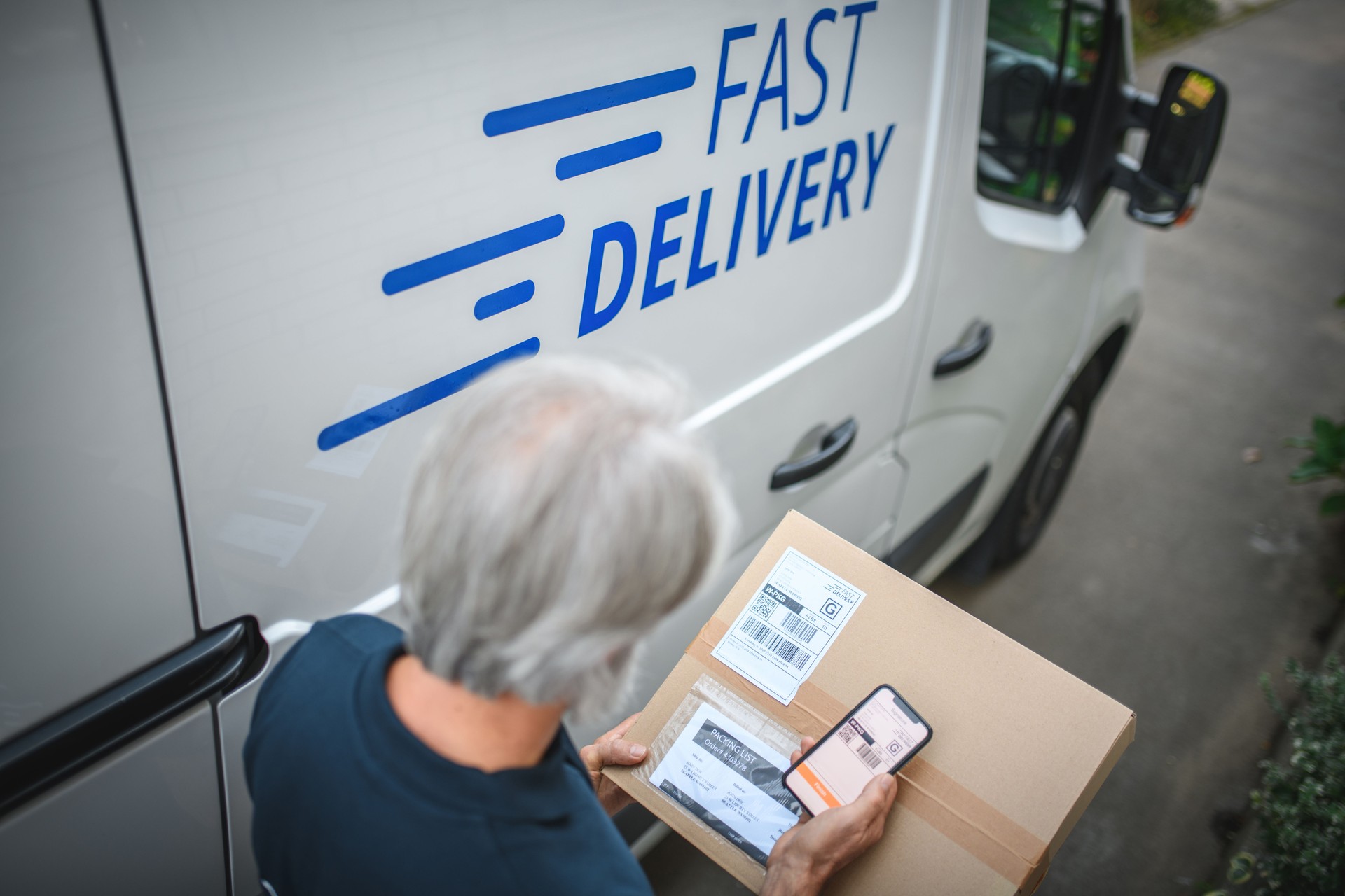 Mature Delivery Man Scanning Label